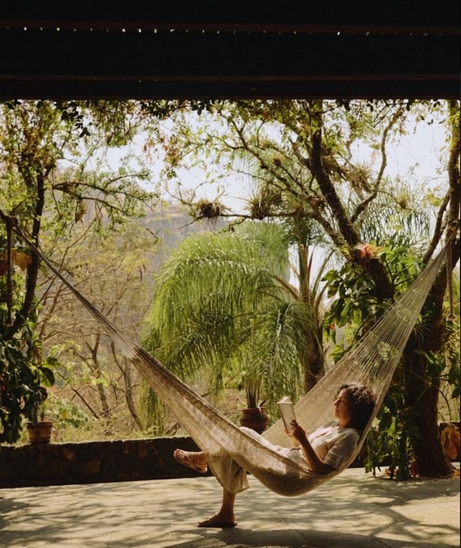 A hammock strung in the shade of the jungle