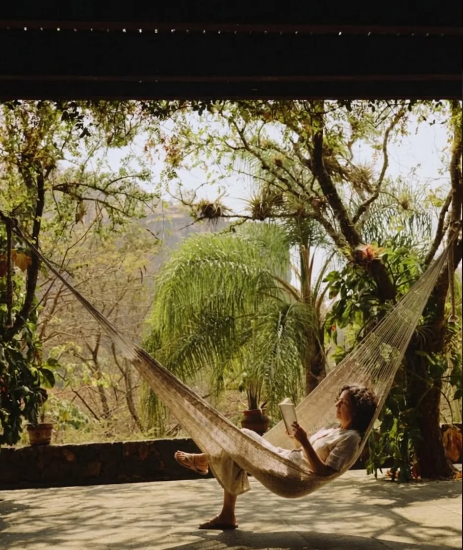 A hammock strung in the shade of the jungle