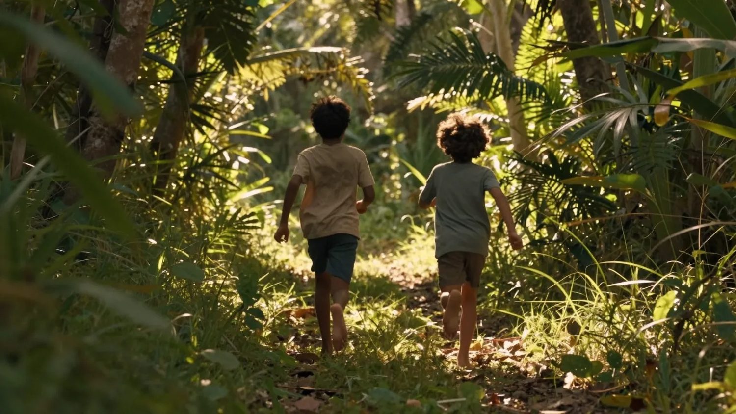 Two children walking a shaded forest trail