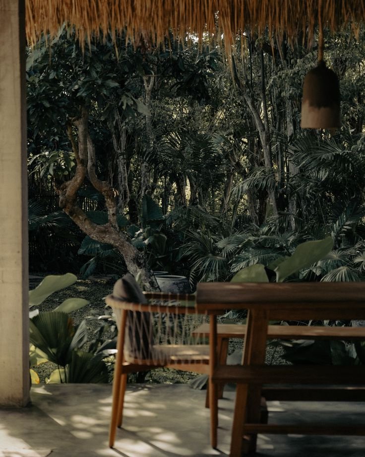 A shaded table on a terrace looking into the garden